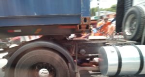 SENHORA É ESMAGADA POR CARRETA AO TENTAR ATRAVESSAR RUA COM A FILHA DEFICIENTE